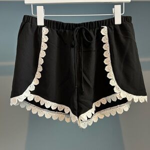 NWT Aqua shorts. Black with white lace trim detail. Size large.Dress up or down!